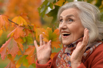 Portrait of senior woman walking in autumn park