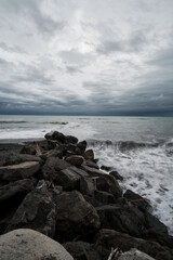 Fototapeta na wymiar rocks on the beach in the storm