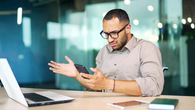 Broken phone, bug, mobile app problems error Dissatisfied man using smartphone. Stressed business man, employee, manager annoyed with glitch or connectivity problem for chat damage sitting in office