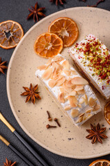 A piece of delicious sweet meringue roll with mascarpone cheese, berries and almonds