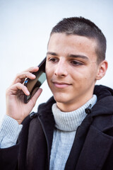 a teenager uses a mobile phone