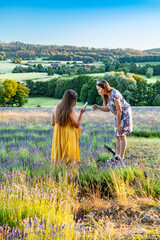 Two women discuss a photo shoot in a lavender field