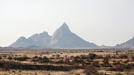 Spitzkoppe Namibia at some distance. Mountain range on a hazy day
