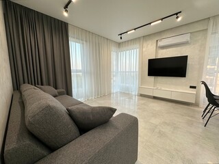 modern living room with sofa and tv, white wall and floor