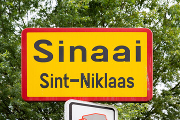Sinaai, East Flemish Region, Belgium - Yellow road sign of the village and municipality of Sinaai, Sint-Niklaas