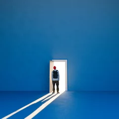 Fototapeten Door open on a large wall and a man backlit in the doorway. Life choices, making decisions, following your own path, having the courage to change. 3d rendering © Naeblys