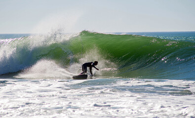 Surfer in action in the tubular waves of the Atlantic Ocean