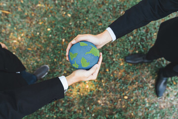 Earth day concept, top view businessman giving Earth globe as CSR corporate social responsible...