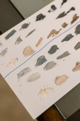 Paint swatches in neutral colors on an artist's palette 