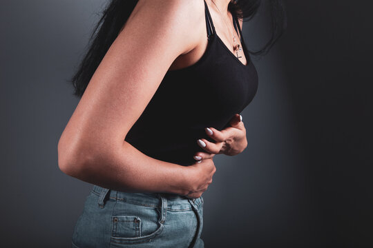 Cropped View Of Woman Holding Stomach In Hand