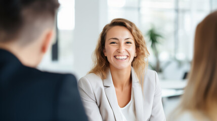 Radiant Businesswoman Smiling with Confidence in Lively Discussion, Office Setting, Professional Workspace