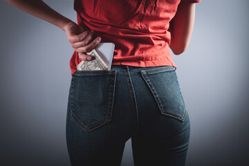young woman holding pocket with jeans.