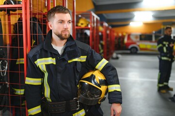 A firefighter puts on a fire uniform at the fire department