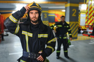 Fototapeta premium Young handsome fireman in the fire department