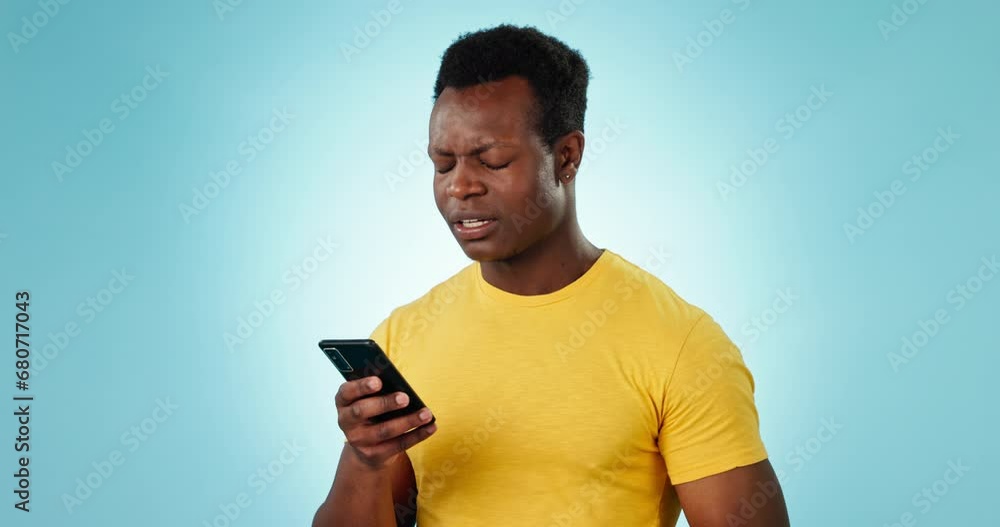 Poster phone, confused and anxiety with an annoyed black man in studio on a blue background for communicati