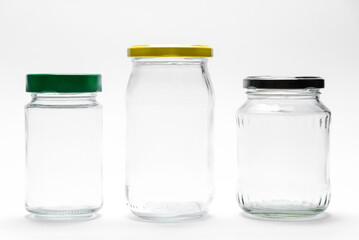 Empty transparent glass jars with lids isolated on white background