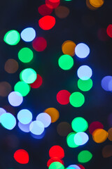Colourful festive bokeh lights on background. Abstract multicolored light. Christmas or New Year holiday concept. Mock up template for greeting card
