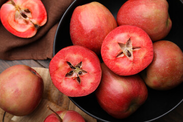 Tasty apples with red pulp on wooden table, flat lay