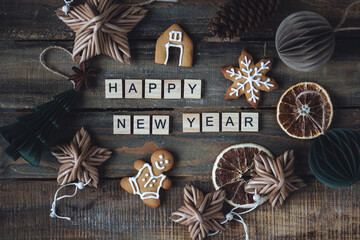 Happy New Year greeting written with wooden blocks . Holidays card on wooden background with...