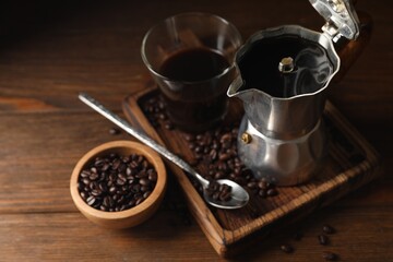 Obraz na płótnie Canvas Brewed coffee, moka pot and beans on wooden table