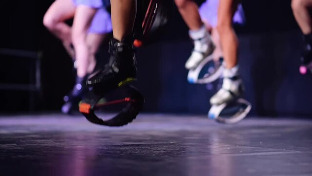 Close-up of Women Doing Exercises with Rebound Boots. Sports, Fitness, Jumpers