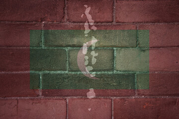 map and flag of maldives on a old brick wall