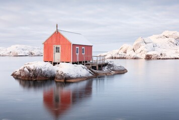 Fototapeta na wymiar red snowy shack in winter on island in, fjordane, light indigo and white, serene oceanic vistas