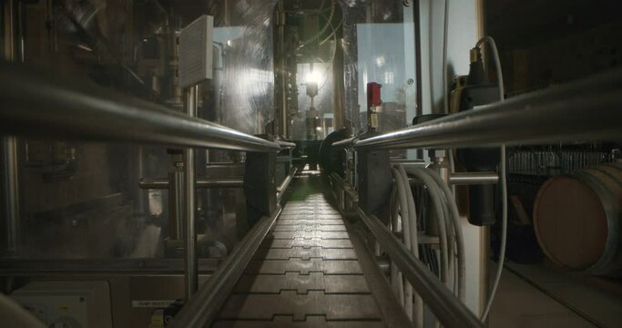 Wine factory, barrels, pipes through which the alcoholic drink flows into the barrels. Wooden barrels are the work of a winemaker. High quality 4k footage