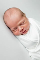 Close up of cute newborn baby sleeping on white background covered.Care,love,happiness concept.