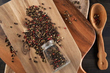Various pepper types on wooden boards