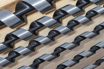 Spiral wood drill bits closeup. Building tools as background - obrazy, fototapety, plakaty