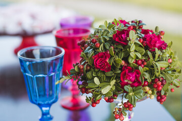 Close-up of a pink and purple floral design on an empty table.