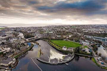 Aerial view on Salmon Weir in River Corrib, Galway city, Ireland. Dramatic cloudy sky. Cityscape...