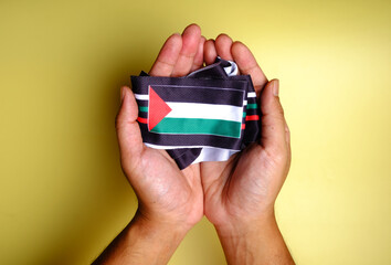 A picture praying hand with Palestinian Flag at side. Pray for Palestine concept
