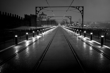 A view of the Dom Luis I Bridge at night in Porto, Portugal. Black and white photo.