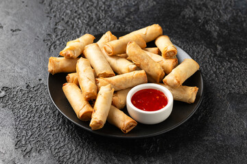 Fried vegetable spring rolls with sweet chilli sauce, party food