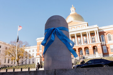 Boston, Massachusetts USA - November 19, 2023: A blue ribbon tied around a post in front of the...