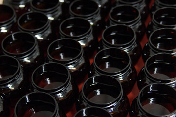 Assorted  bottles in a row, close-up arrangement, indoor backdrop.