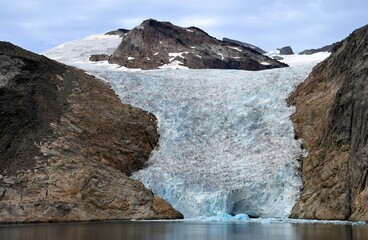 spectacular sermeq kajatleq  glacier in the steep mountains of the prince christian sound, in...