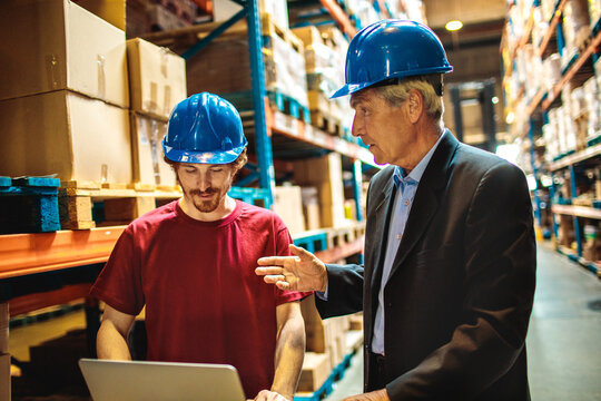 Senior Manager and Warehouse Employee Discussing Inventory