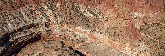 Panorama of Sulfur Creek twisting through the canyon below Goosenecks Overlook at Capitol Reef National Park, Utah, USA