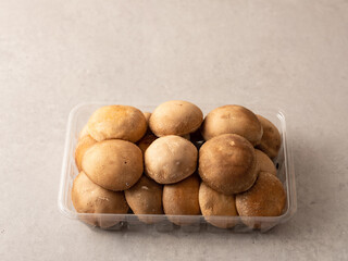 Shiitake mushrooms in a plastic container