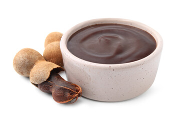 Bowl of tamarind sauce and fresh pods isolated on white