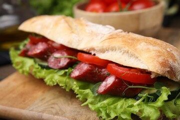 Delicious sandwich with sausages and vegetables on table, closeup