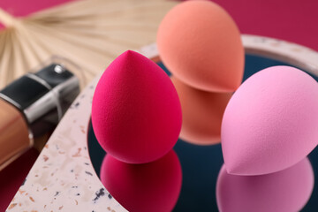 Stylish presentation of makeup sponges on pink background, closeup - obrazy, fototapety, plakaty
