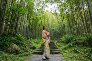 Woman wear kimono in the bamboo forest