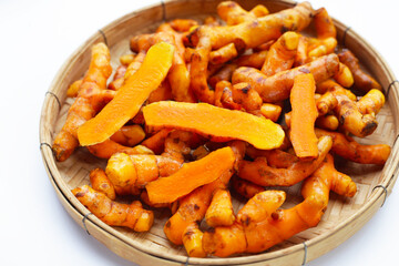 Turmeric roots on white background.