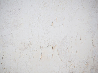 Ceiling of an old apartment. Crumbling plaster. The housing requires renovation. Background made of peel-off coating.