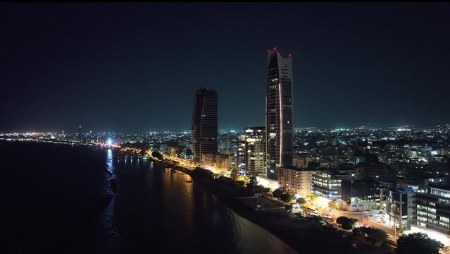 Aerial view of the cityscape of Limassol at night. Street light, light from the windows of high-rises and buildings. High quality 4k footage