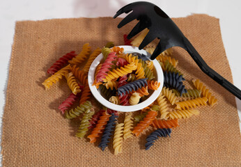 multicolor spiral pasta in bowl ,top view